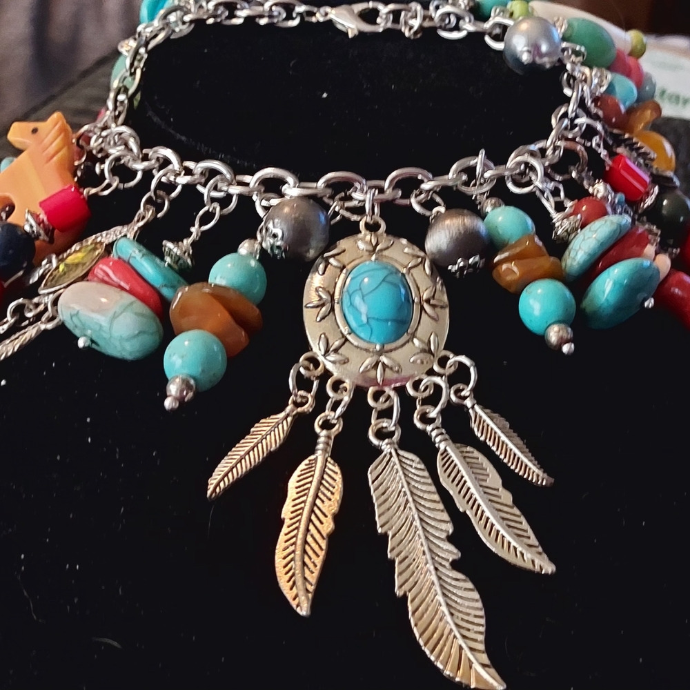 Handcrafted Turquoise And More. Silvertone Charm Bracelet with Feather Details